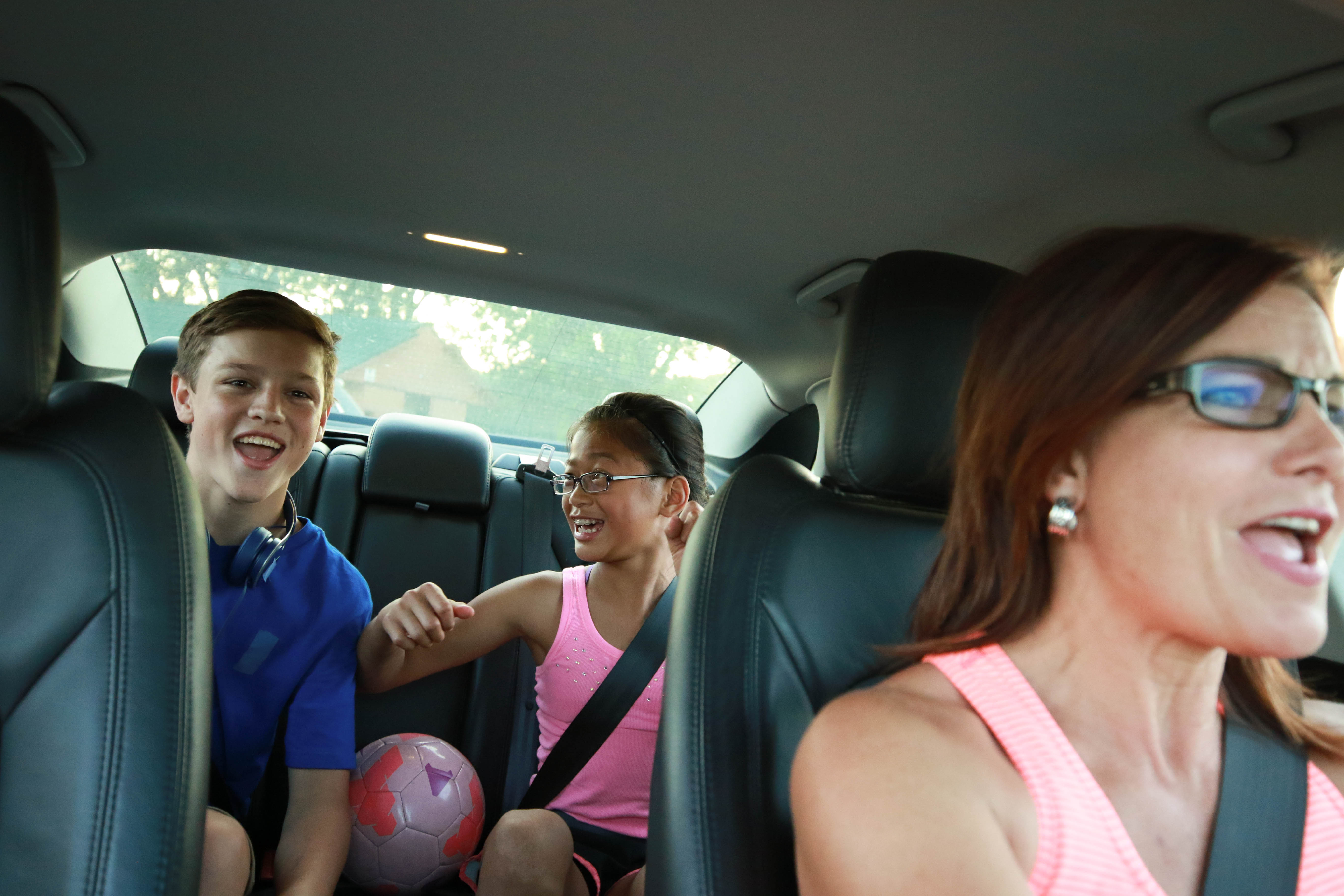 Mom with kids in car carpooling