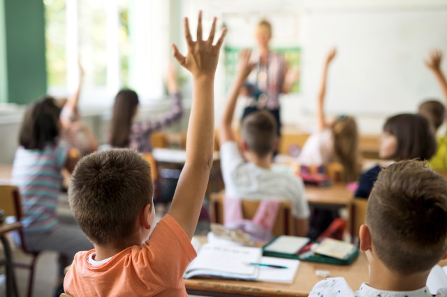 Child raising their hand in classroom