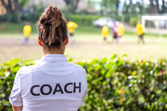 Back view of a female soccer coach