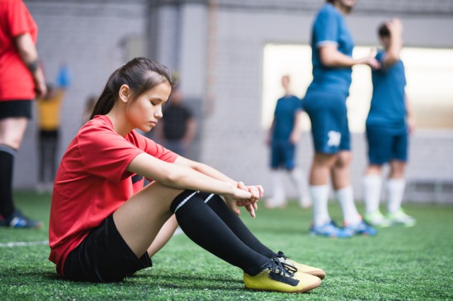 Female football player in sports uniform