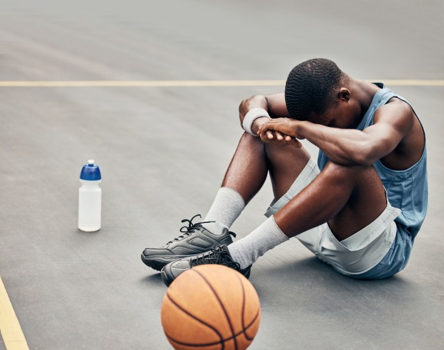 Man sitting on basketball court