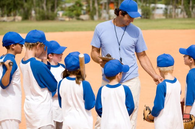 Youth Baseball Coach With Team