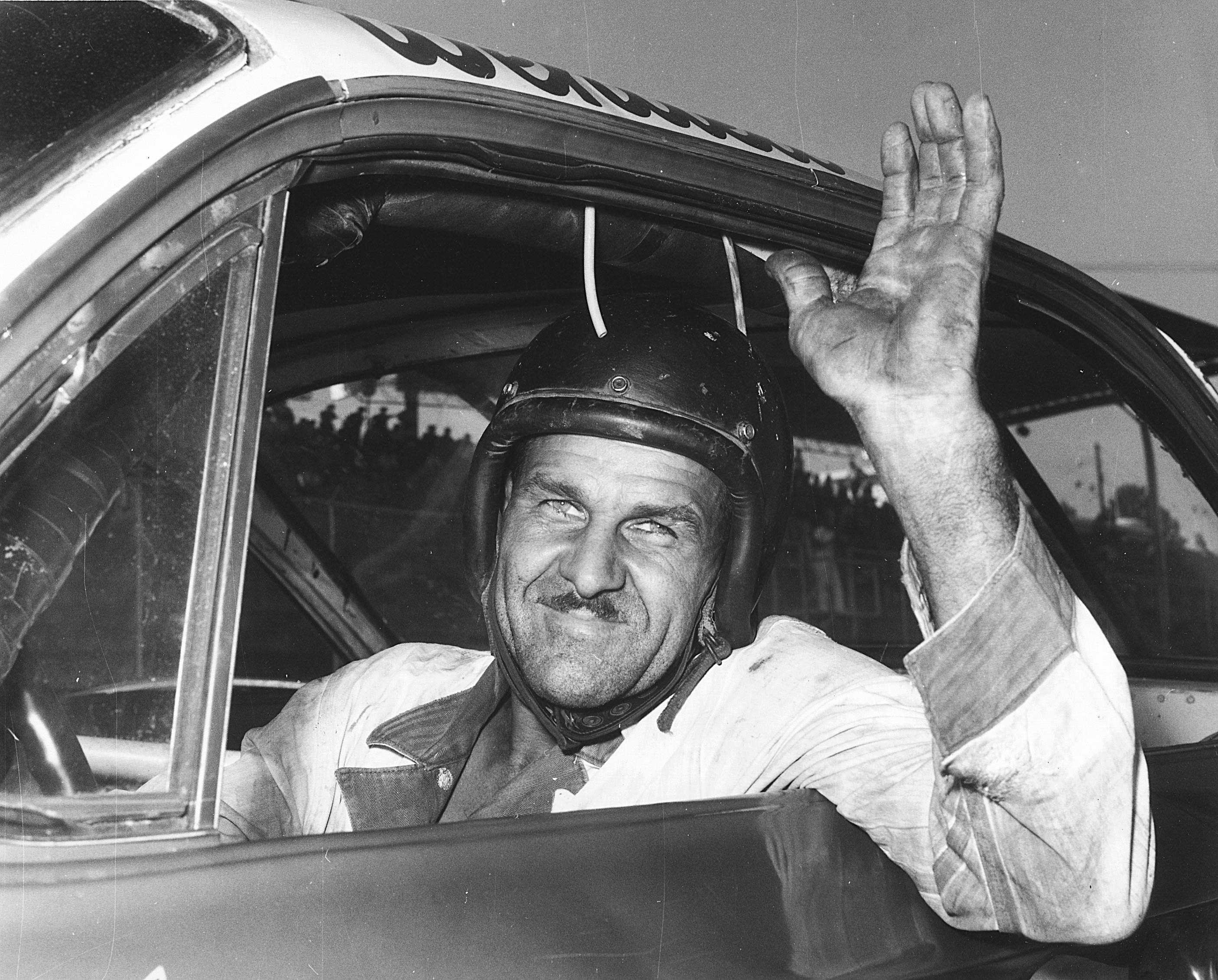 Wendell Scott waving from his car on the Jacksonville Speedway