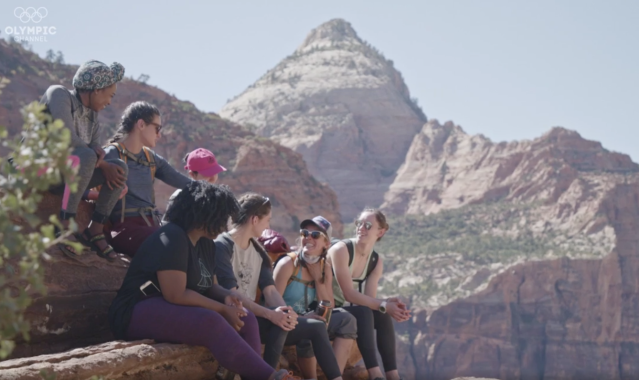 Hiking Group Sitting Atop Cliff