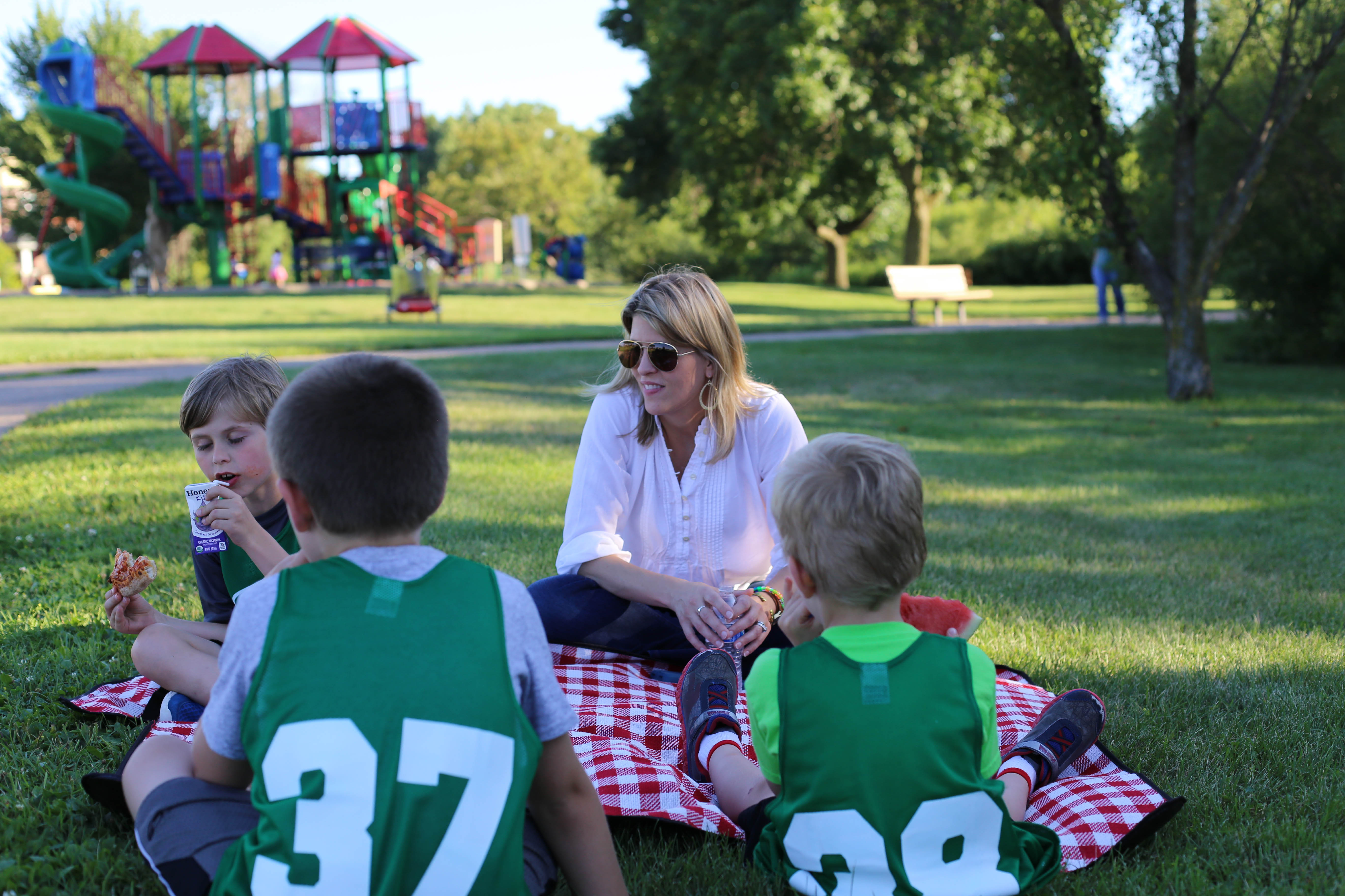 mom with kids on picnic blanket