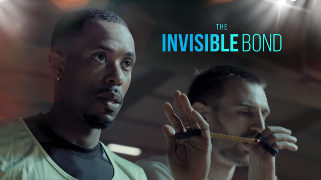 Screen shot of Invisible Bond Documentary cover featuring athlete and his guide with blue text overlayed