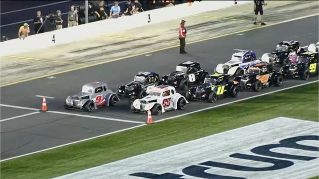 Legends cars lined up at the starting line at Charlotte Motor Speedway 