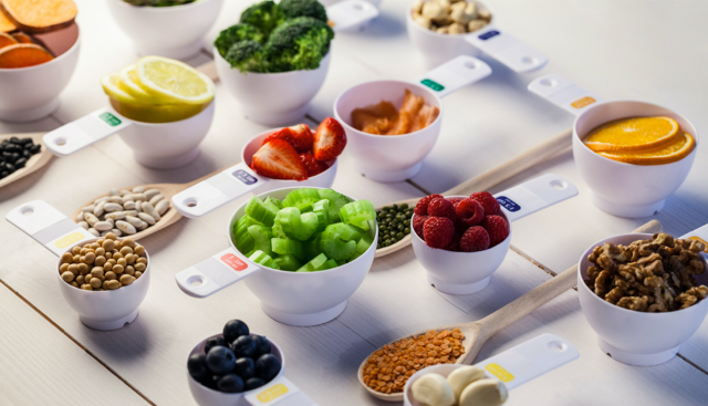 Portion cups of healthy ingredients on wooden table