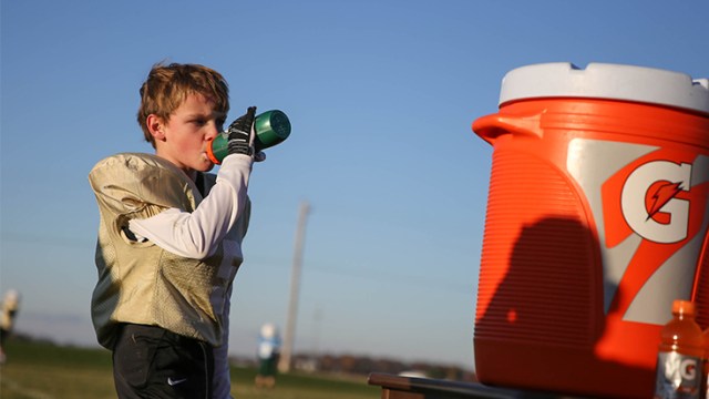Football player drinking from water bottle