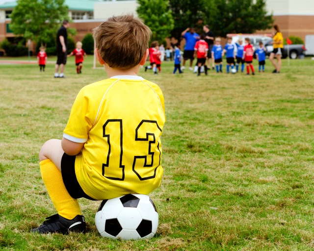 boy watching soccer team