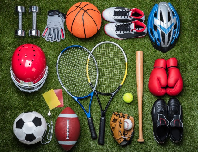 Various Sport Equipments On Green Grass