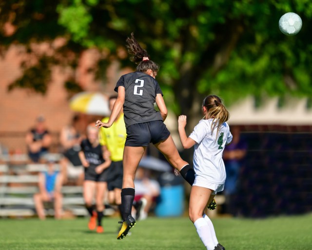Soccer player heading the ball during a game