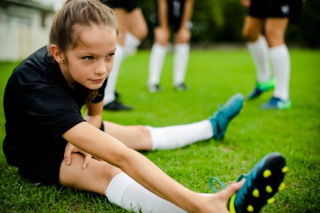 Girls stretching on the field