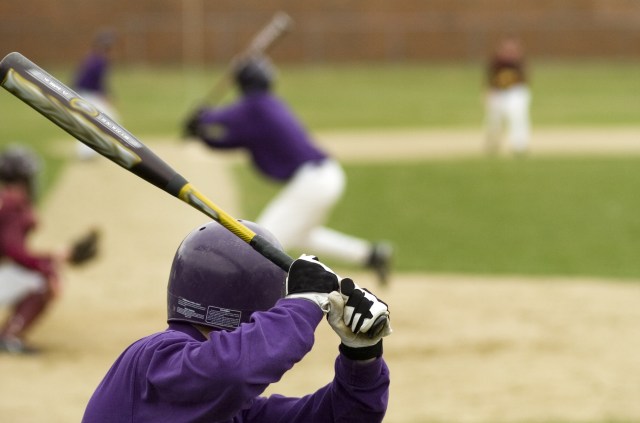 Batter about to swing a baseball bat while warming up coaches point of view