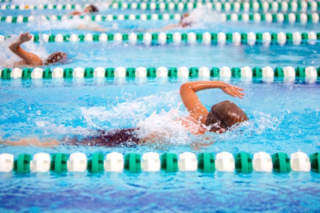 Freestyle swimmers in a race, motion blur on swimmer