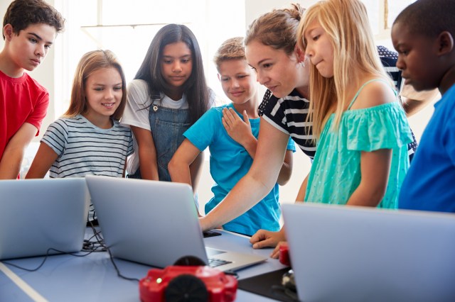 Group of students around a computer