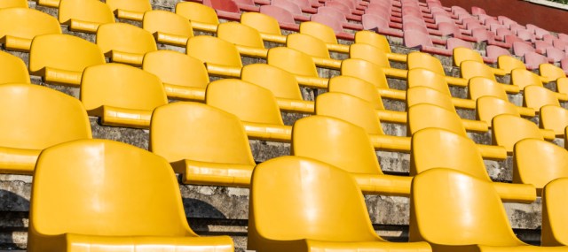 The seats of the old stadium. Old stadium stand close-up.