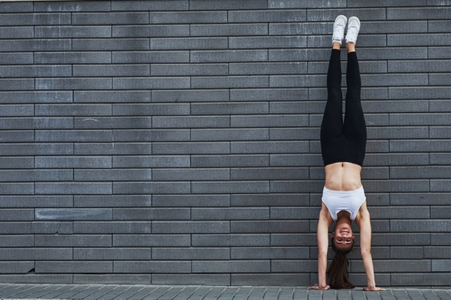 young woman doing handstand
