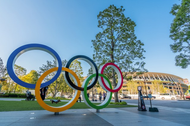 The five ring symbol of the Olympic Games at tokyo museum and new stadium in background
