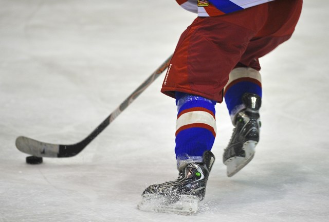 Unidentified players in action at hockey match with CSM Dunarea Galati (white) and CSS HSC Csikszereda (blue)