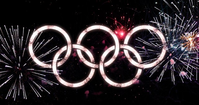 Logo rings of the Olympic Games with fireworks in the background
