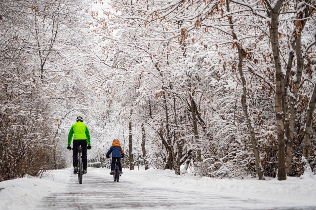 Father and son riding bikes in the winter