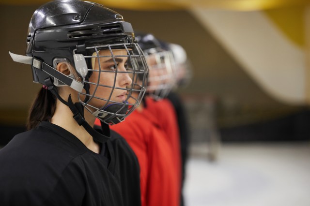 Side view portrait of female hockey team