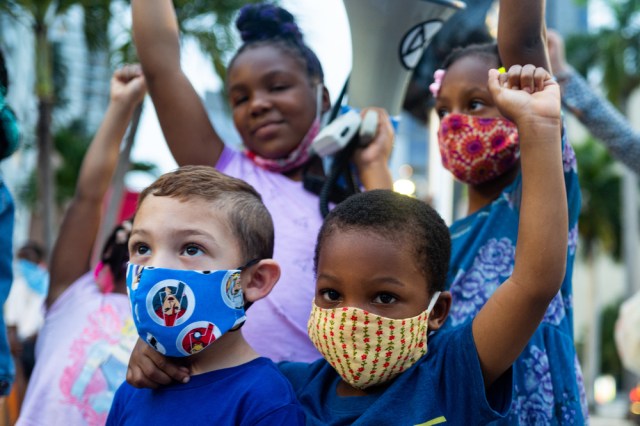 White and black boys together. Friends. Anti racism demonstration. Children of different races together