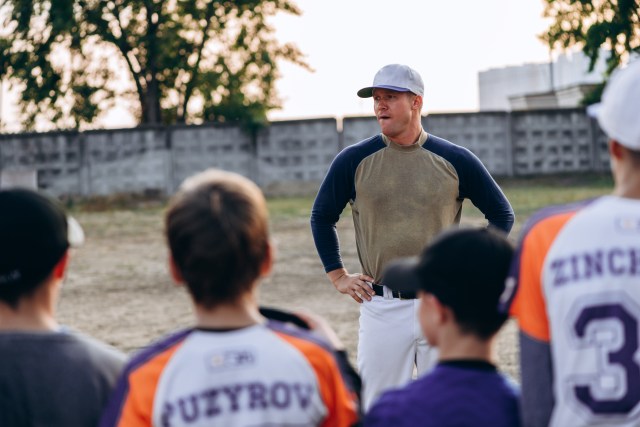 Baseball coach coaching youth athletes