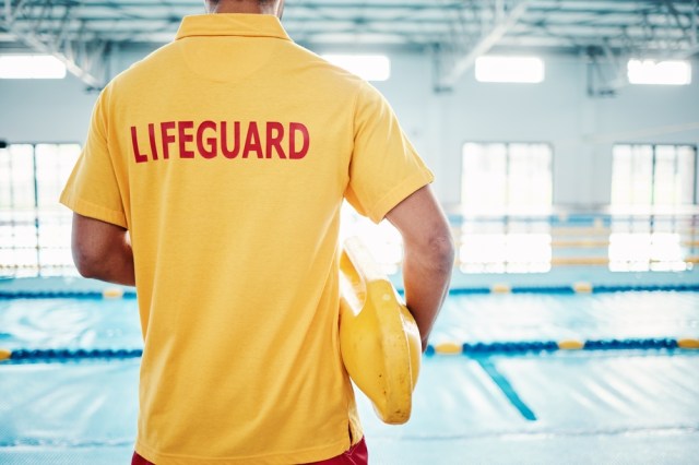 Lifeguard by swimming pool