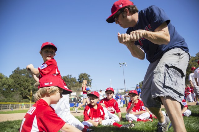 coach teaches Tee-Ball Division players