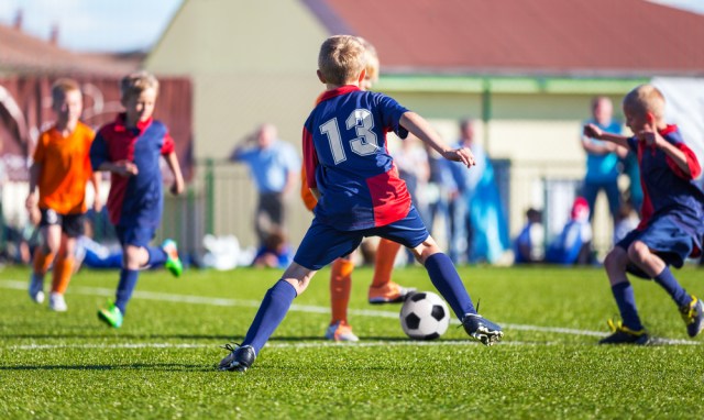 Boys Play Football; Children kicking Soccer Ball; Football Tournament for Youth Sports Teams