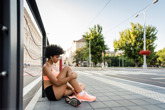 Tired woman sits after fitness exercise