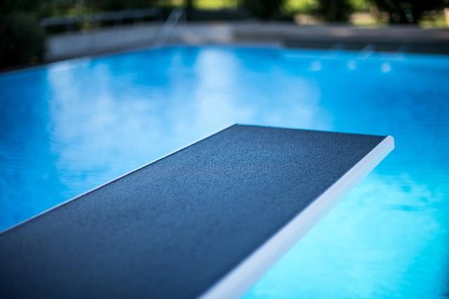 Closeup view of diving board in swimming pool
