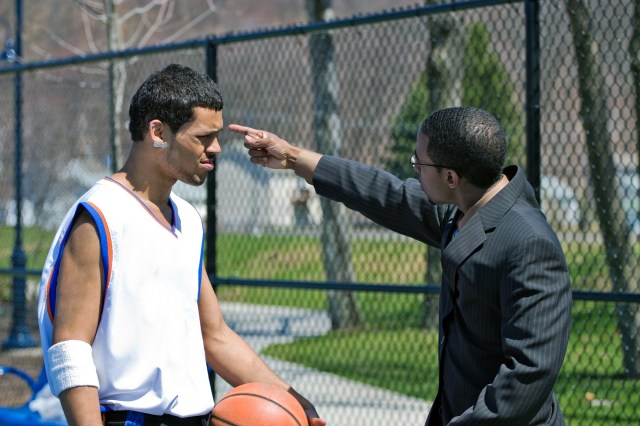 A young basketball player gets yelled at by his coach.