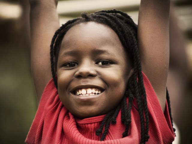 girl hanging on bars