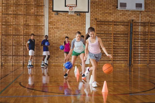 students basketball dribbling